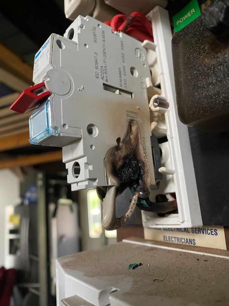 Burnt and melted main switch in an Adelaide residential switchboard after severe overheating.